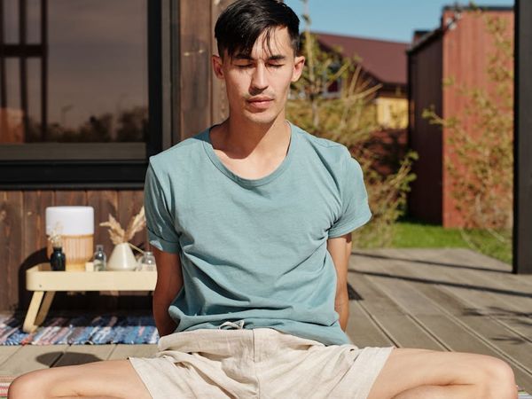 Man stretching with closed eyes in a calm environment